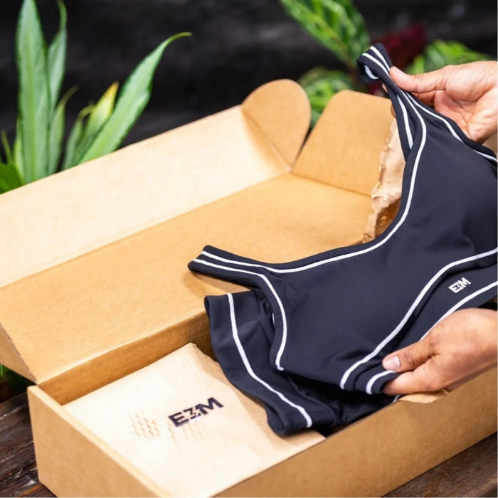 E3M Performance Sports Bra being unpacked from an E3M branded box
